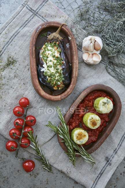 Two baked vegetable dishes in rustic serving trays (top view) — Stock Photo