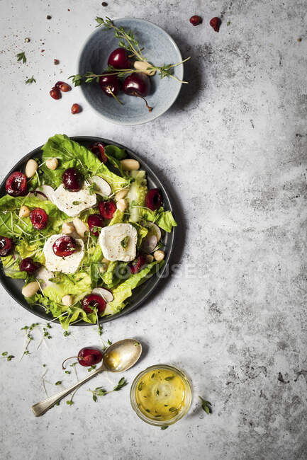 Salad with cherries, goats cheese and herbs — Stock Photo