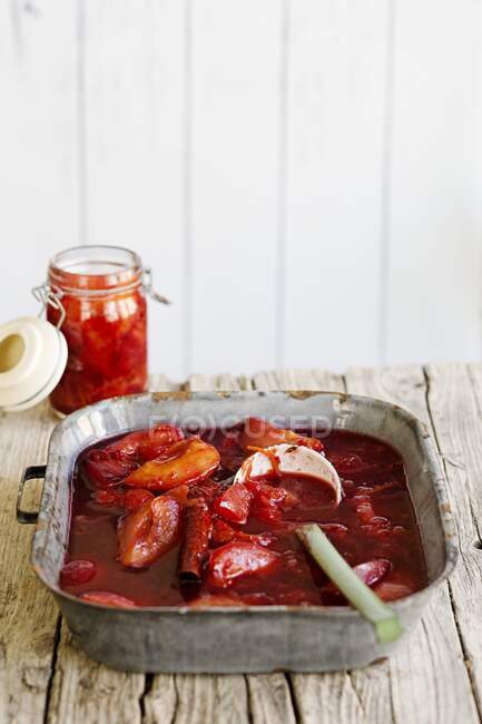 Plum compote with a glass jar — Stock Photo