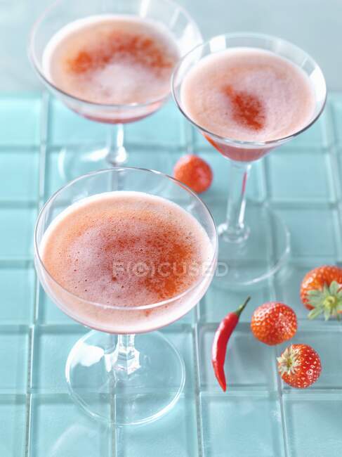 Erdbeer-Chili-Bellinis-Cocktails in Gläsern auf blauem Hintergrund — Stockfoto