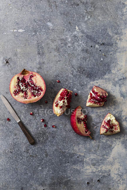 Pomegranate cut into pieces — Stock Photo