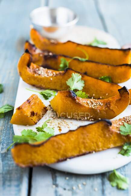 Oven baked pumpkin wedges with miso paste — Stock Photo
