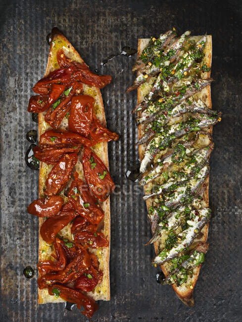 Tomato and anchovy baguette — Stock Photo
