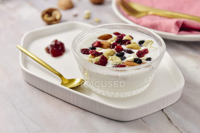 Yogurt with nuts topping — Stock Photo