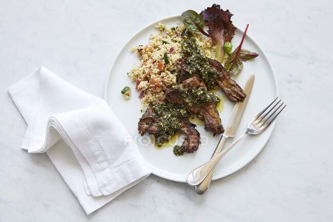 Lamb chops with salsa verde and couscous — Stock Photo