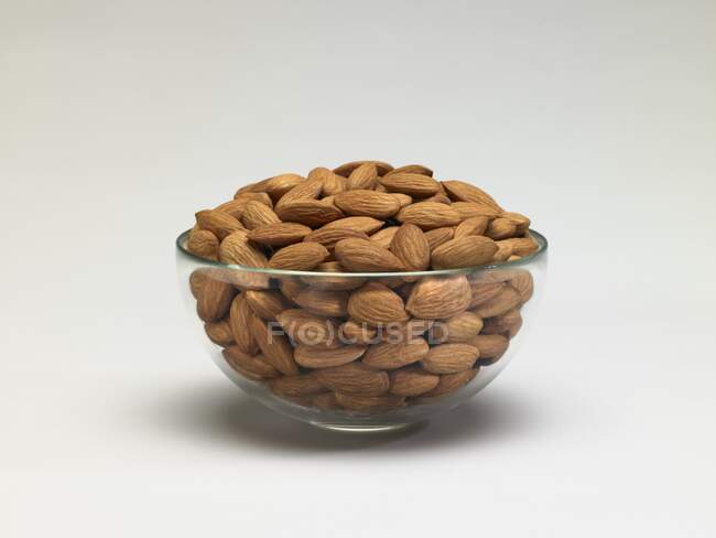Almonds in glass bowl — Stock Photo