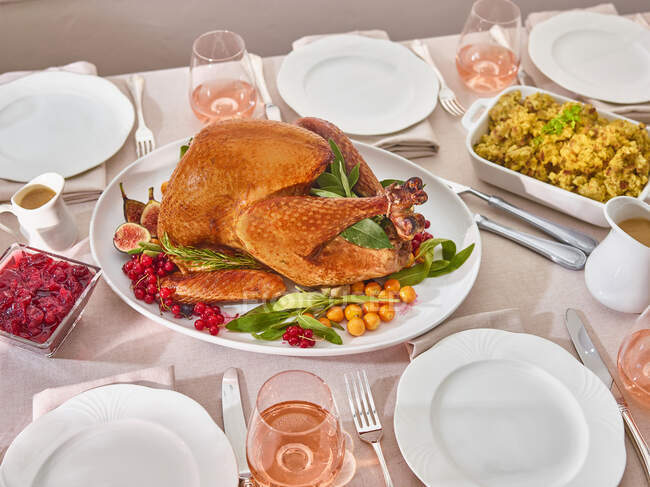 Set table with roast turkey and side dishes — Stock Photo