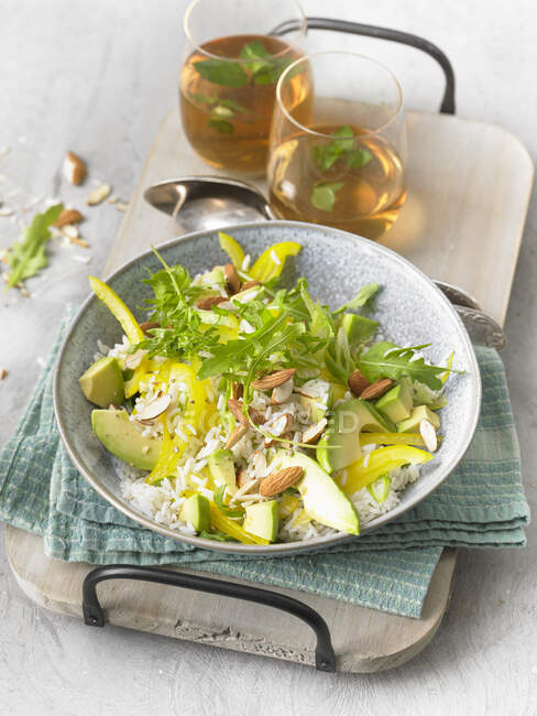 Rice salad with avocado, almonds and rocket — Stock Photo