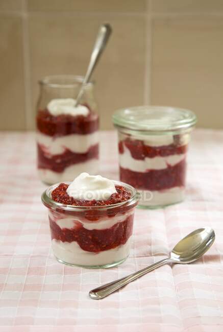 Vegan yoghurt dessert with raspberries layered in glasses — Stock Photo