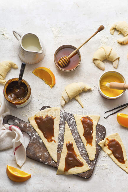 Baking croissants with orange caramel cream — Stock Photo