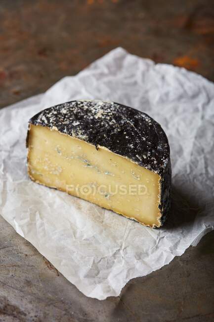 Blue cheese with mold on paper wrap — Stock Photo
