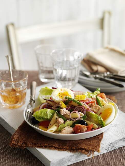 Nizza salad with tuna and eggs served on table — Stock Photo