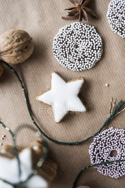 Christmas biscuits, a walnut and star anise on brown paper — Stock Photo