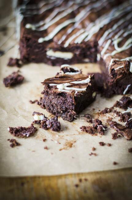 Chocolate brownie with dark and white drizzle — Stock Photo