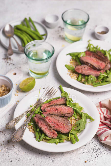 Beef slices with green beans and white sorghum — Stock Photo