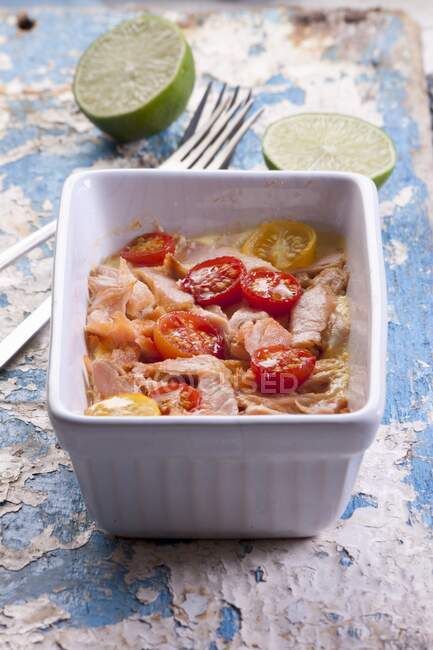 Oven-baked salmon and tomatoes in ceramic tin — Stock Photo