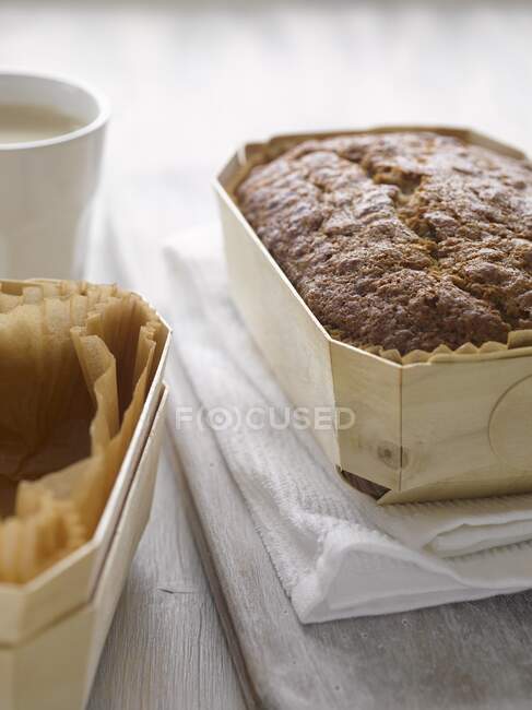 A loaf of banana bread in a woodchip basket — Stock Photo