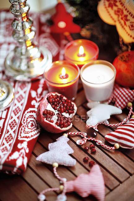 Pomegranate on a wooden table with Christmas decoration — Stock Photo