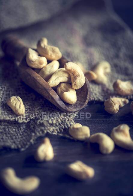 An arrangement of cashew nuts on a wooden scoop — Stock Photo