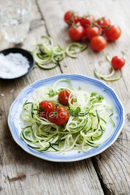 Spiralized courgettes with roasted vine tomatoes — Stock Photo