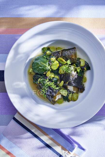Monkfish with algae and green fava beans — Stock Photo