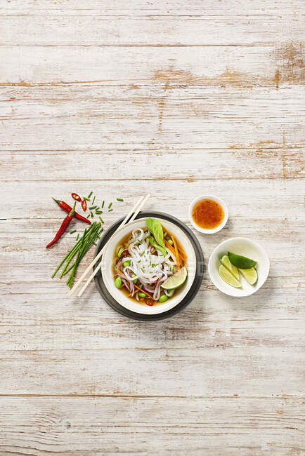 Top view of thai food with vegetables and sauce on wooden background — Stock Photo