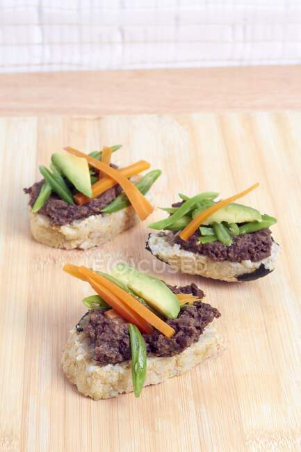 Rice bread with adzuki bean cream, carrot sticks and avocado — Stock Photo