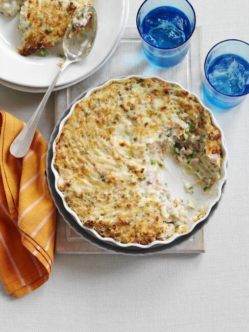 Mashed potatoes and bacon pie, with portion removed — Stock Photo