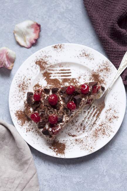 Tiramisu with cherry and chocolate on a white plate — Stock Photo