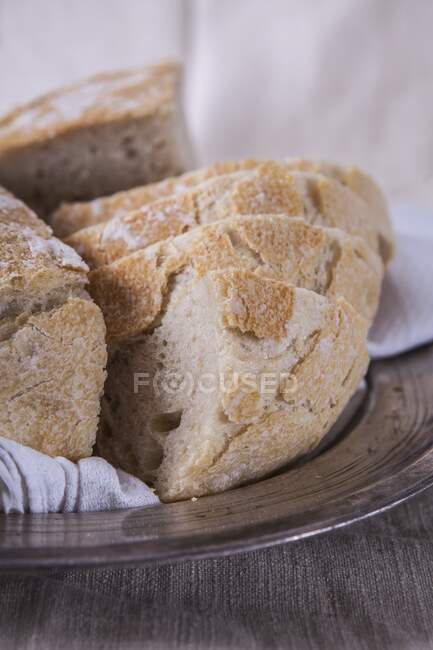Wheat bread baked in a tin: sliced on a silver plate — Stock Photo