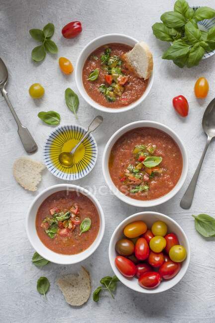 Gazpacho soup with salsa, basil and olive oil — Stock Photo