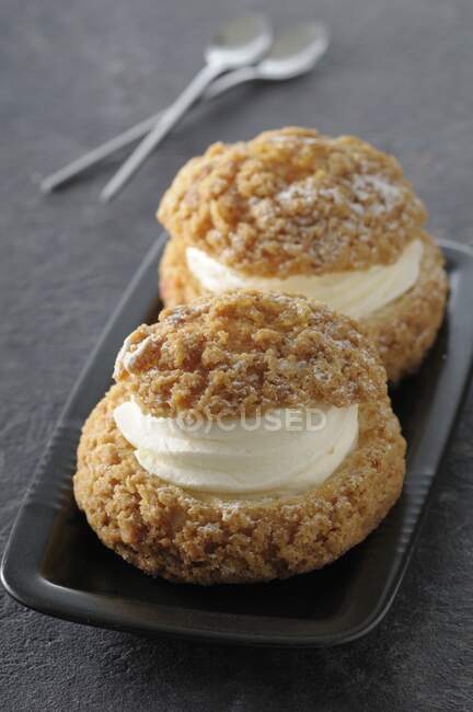 Choux Craquelin with cream filling (profiteroles topped with streusel, France) — Stock Photo