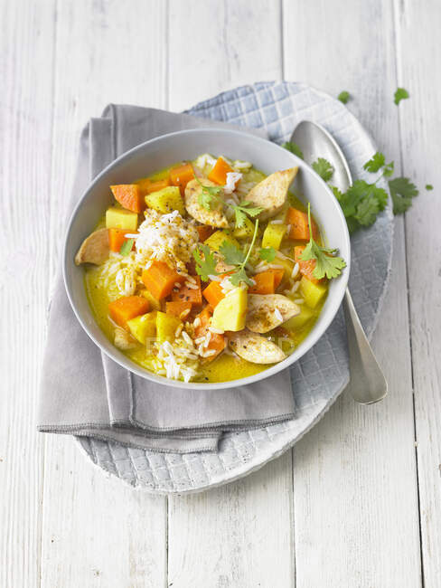 Chicken stew with rice, carrots, potatoes and coriander greens — Stock Photo