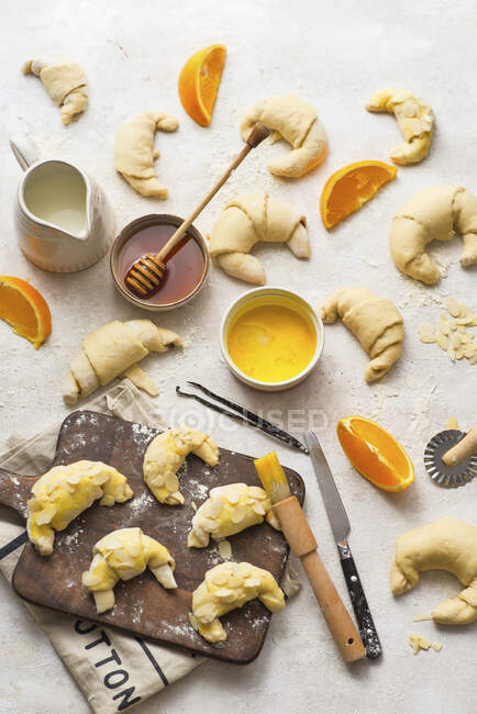 Baking croissants with orange cream and almonds — Stock Photo