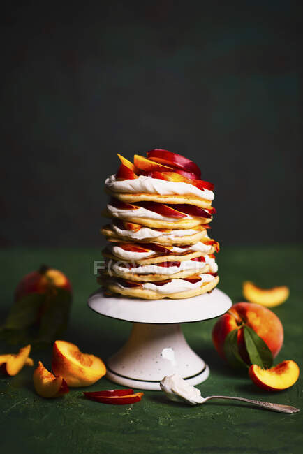 Pancakes cake with sweet creamy cheese and peaches — Stock Photo