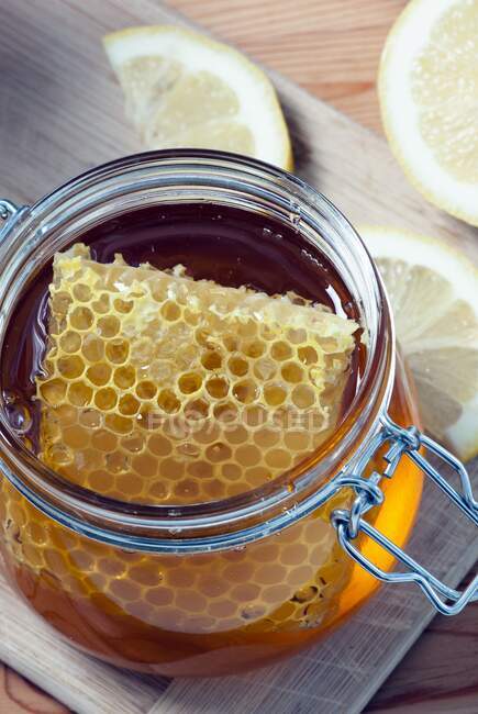 Miel grec bio avec nid d'abeille dans un bocal en verre — Photo de stock