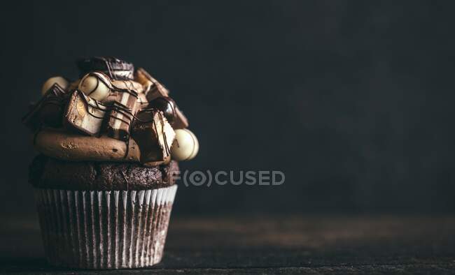 A chocolate cupcake with sweets on the top for a party — Stock Photo
