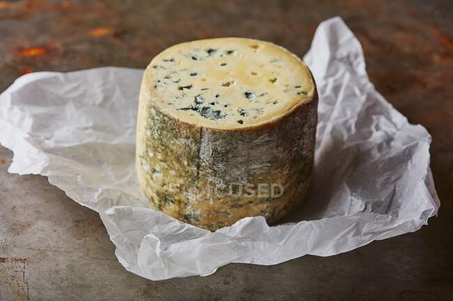 Blue mold cheese on paper wrap — Stock Photo