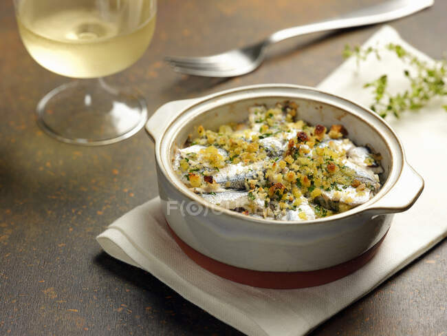 Anchovy gratin in a cocotte — Stock Photo