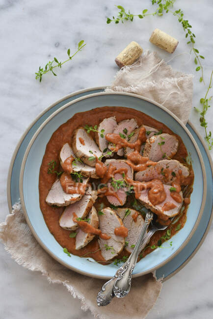 Pork tenderloin with apricot sauce and fresh herbs — Stock Photo