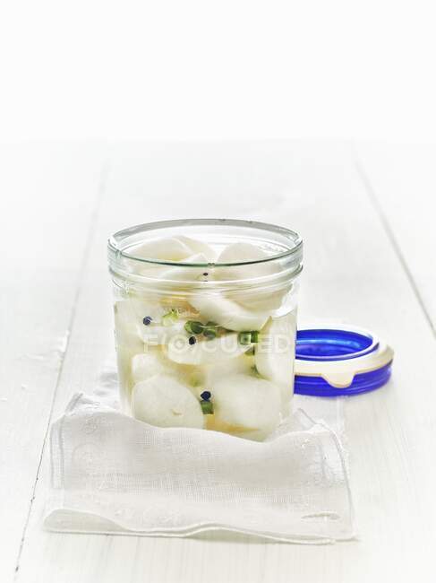 Lacto fermented daikon radishes in a mason jar — Stock Photo