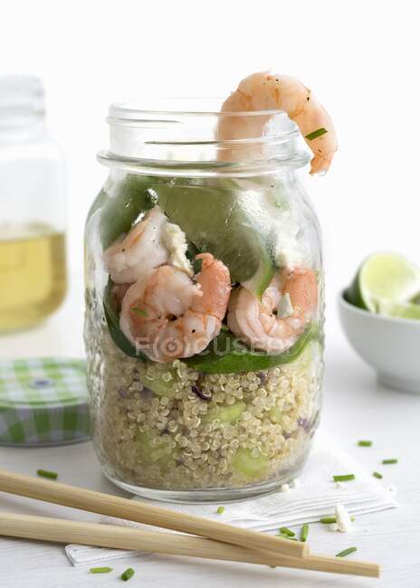 Giant prawns and quinoa in a glass with lime and baby spinach — Stock Photo
