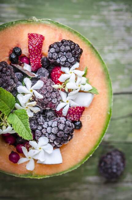 Melon with iced berries — Stock Photo