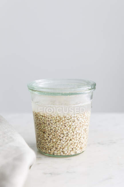 Overnight buckwheat being softened in water — Stock Photo