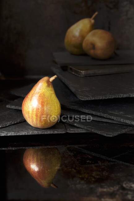 A pear reflected in water — Stock Photo