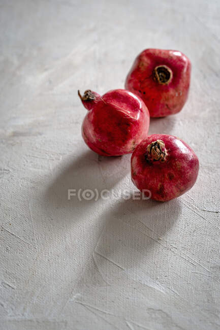 Ripe red pomegranate on a wooden background — Stock Photo