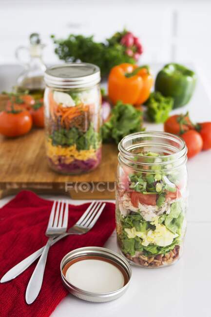 Layered salad in glass with spinach, beans, cheese and egg — Stock Photo