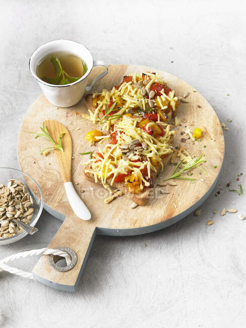 Baked vegetable toasts with cheese and seeds — Stock Photo