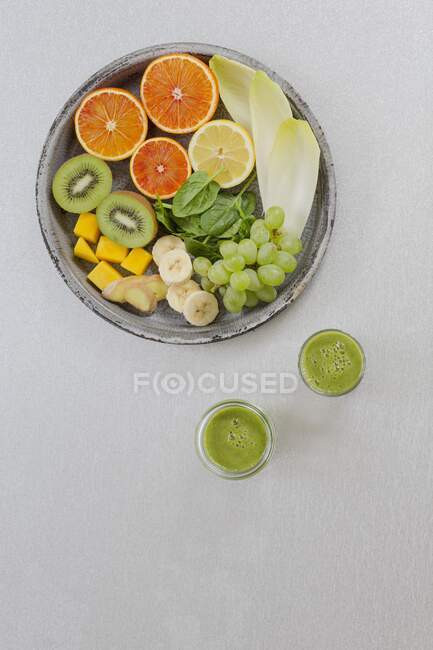 Smoothies verdes e ingredientes em um fundo branco — Fotografia de Stock