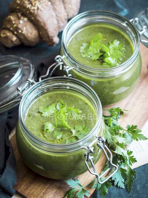 Vegan cream of baked zucchini, sweet potato and spinach soup served in mason jars — Stock Photo